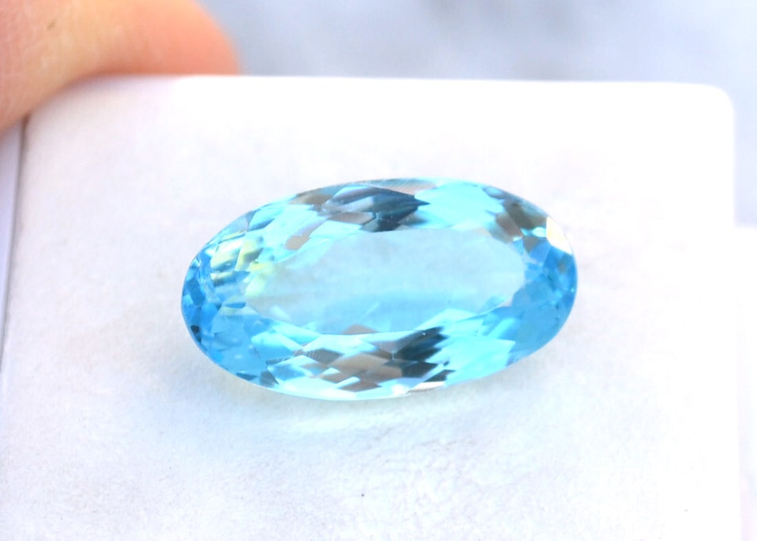 10.41 Carat Oval Cut Intense Sky Blue Topaz: Fantastic Topaz with vivid color. Just a fantastic stone for use in jewelry. Natural stone but heated and irradiated to get its color as all Blue Topaz are. This is an industry accepted practice appli