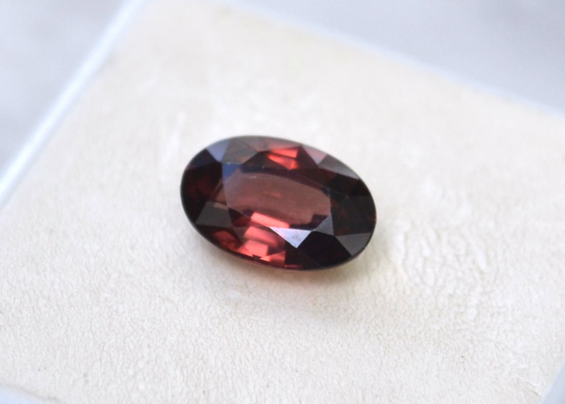 3.53 Carat Oval Cut Zircon: Beautiful Wine Red Zircon. Large and colorful with good clarity and cutting. Slightly on the darker end, which is why the price is so low. But a very nice stone. Zircon is a natural stone, not to be c
