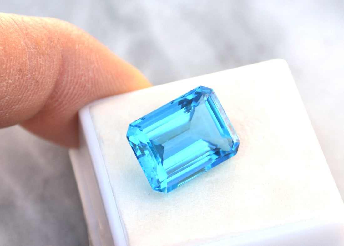 14.59 Carat Octagon Cut Intense Sky Blue Topaz: Beautiful Topaz with an intense Sky Blue color. Just a great stone for the price. Natural stone but heated and irradiated to get its color as all Blue Topaz are. This is an industry accepted practice