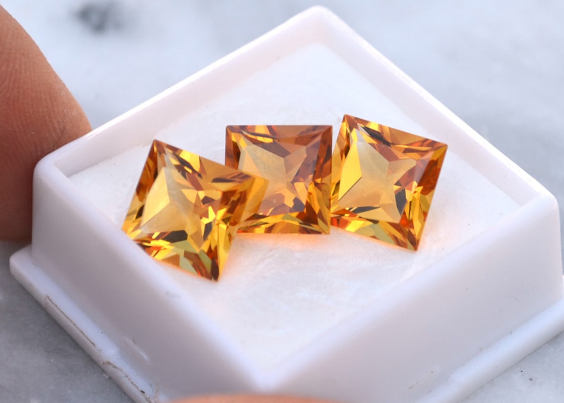 13.46 Carat Matched Trio of Princess Cut Citrines: Gorgeous Citrines. Just exceptional stones and well matched. A great set. Natural and untreated. Most gems sold online aren't jewelry grade. They're either poorly cut, have weak color or too many incl