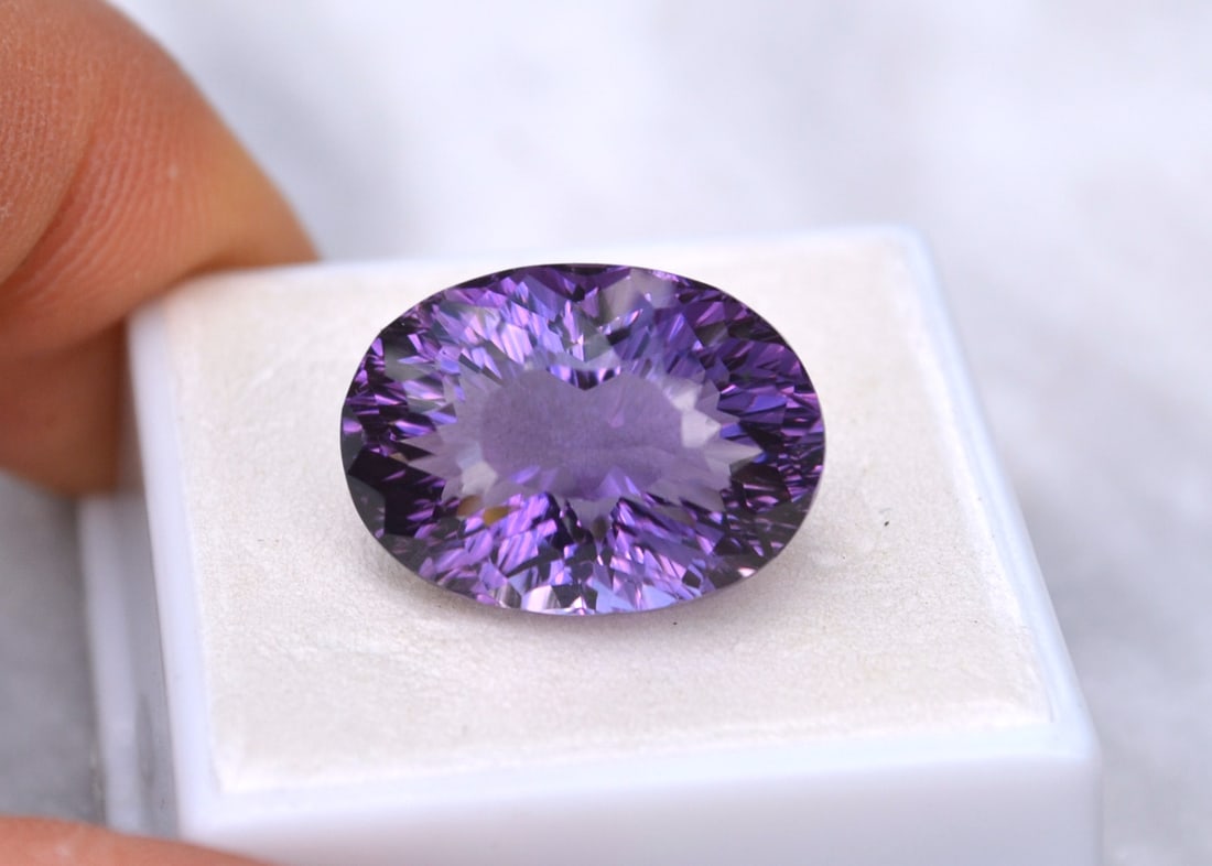 17.57 Carat Fancy Oval Cut Amethyst: Fine Amethyst with a great fancy cut. Just a superb stone. Natural and untreated. For Proxibid bidders, shipping is a flat rate of $6, no matter how many lots won. For Live Auctioneers bidders,