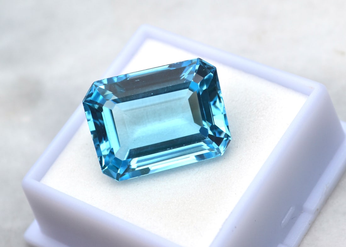 27.90 Carat Octagon Cut Intense Sky Blue Topaz: Beautiful Topaz with vivid color. Just a great stone for the price. Natural stone but heated and irradiated to get its color, as all Blue Topaz are. This is an industry accepted standard applied to