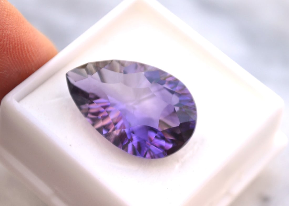 18.52 Carat Fancy Pear Cut Amethyst: Beautiful Amethyst in every way. Just a great stone for the price. Natural and untreated. Most gems sold online aren't jewelry grade. They're either poorly cut, have weak color or too many