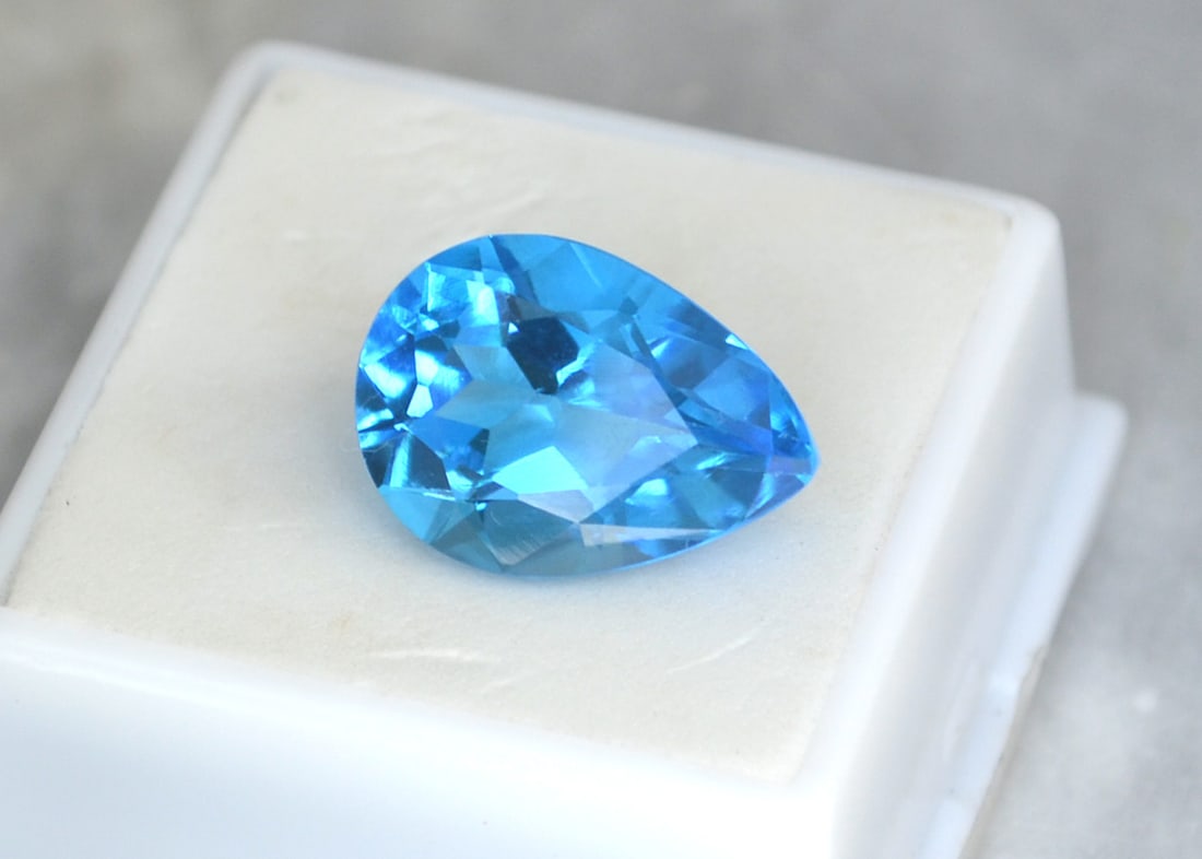 13.43 Carat Pear Cut Swiss Blue Topaz: Great Topaz with fine color, clarity and a great cut. Just a great stone for the price. Natural stone but heated and irradiated to get its color, as all Blue Topaz are. This is an industry accepted