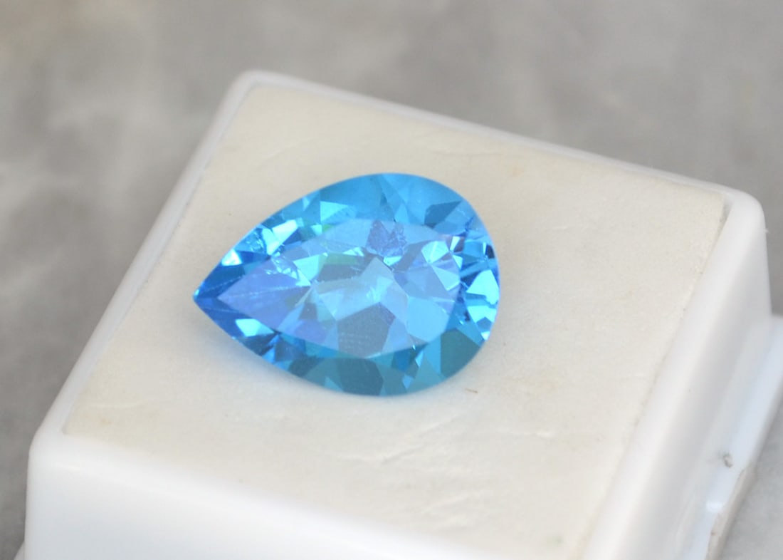 14.12 Carat Pear Cut Swiss Blue Topaz: Beautiful Topaz with fine color, clarity and a great cut. Just a great stone for the price. Natural stone but heated and irradiated to get its color, as all Blue Topaz are. This is an industry