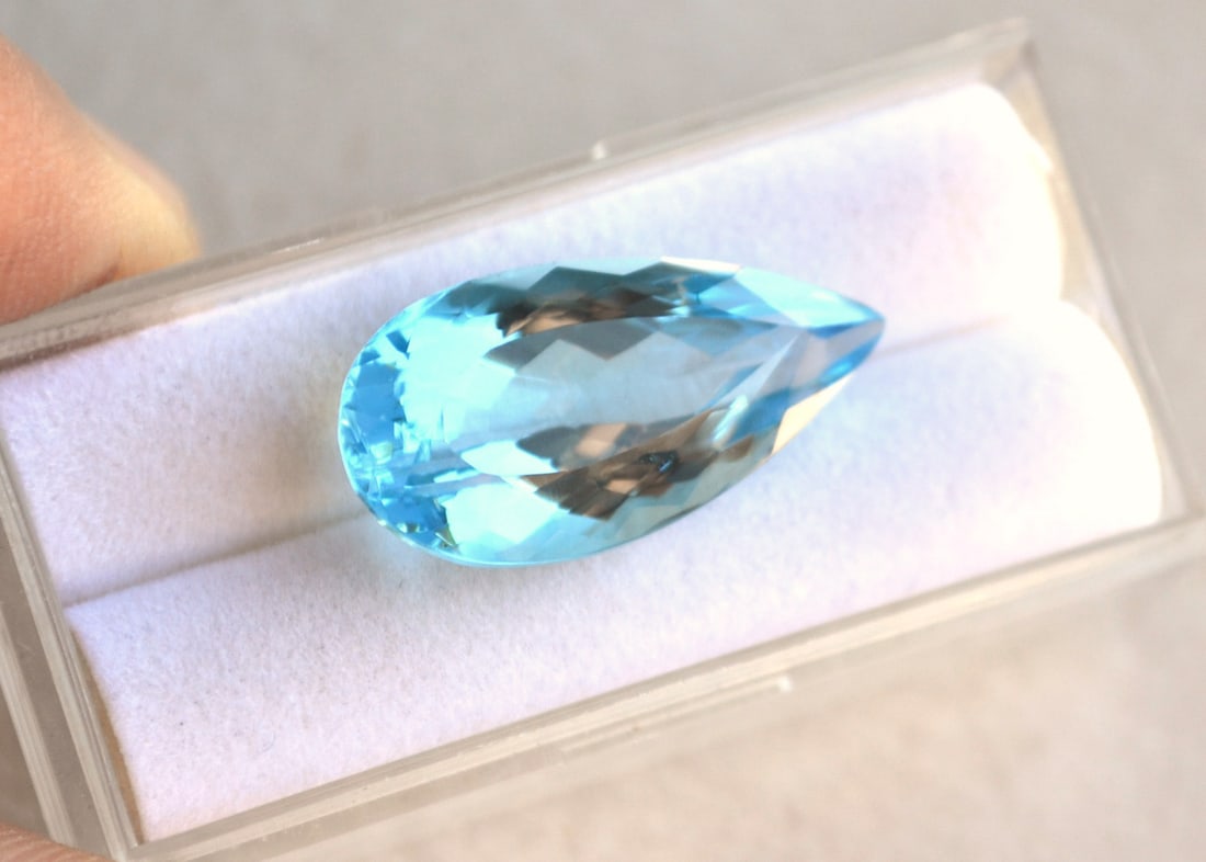 21.05 Carat Pear Cut Sky Blue Topaz: Just a beautiful Sky Blue Topaz here. Natural stone but heated and irradiated to get its color, as all Blue Topaz are. This is an industry accepted practice applied to all Blue Topaz. Most gems sold