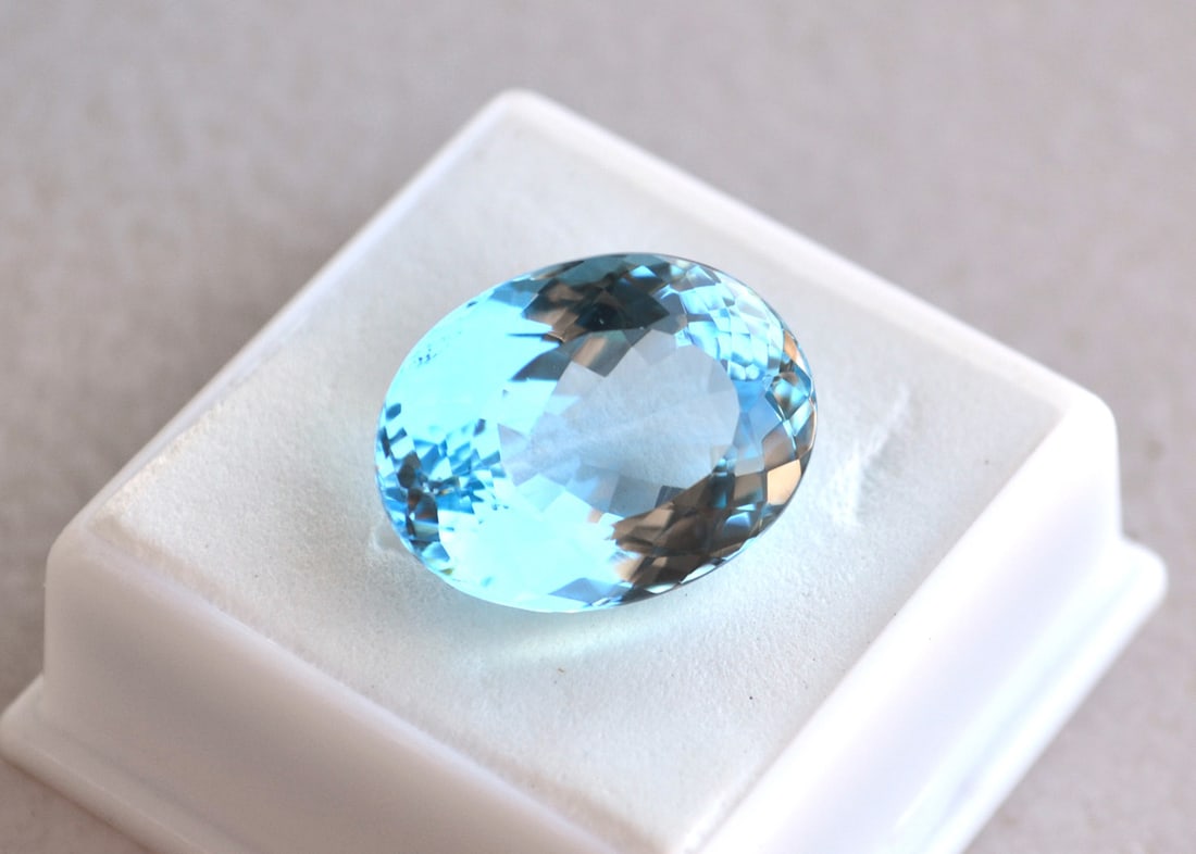 23.47 Carat Oval Cut Sky Blue Topaz: Just a beautiful Sky Blue Topaz here. Natural stone but heated and irradiated to get its color, as all Blue Topaz are. This is an industry accepted practice applied to all Blue Topaz. Most gems sold o