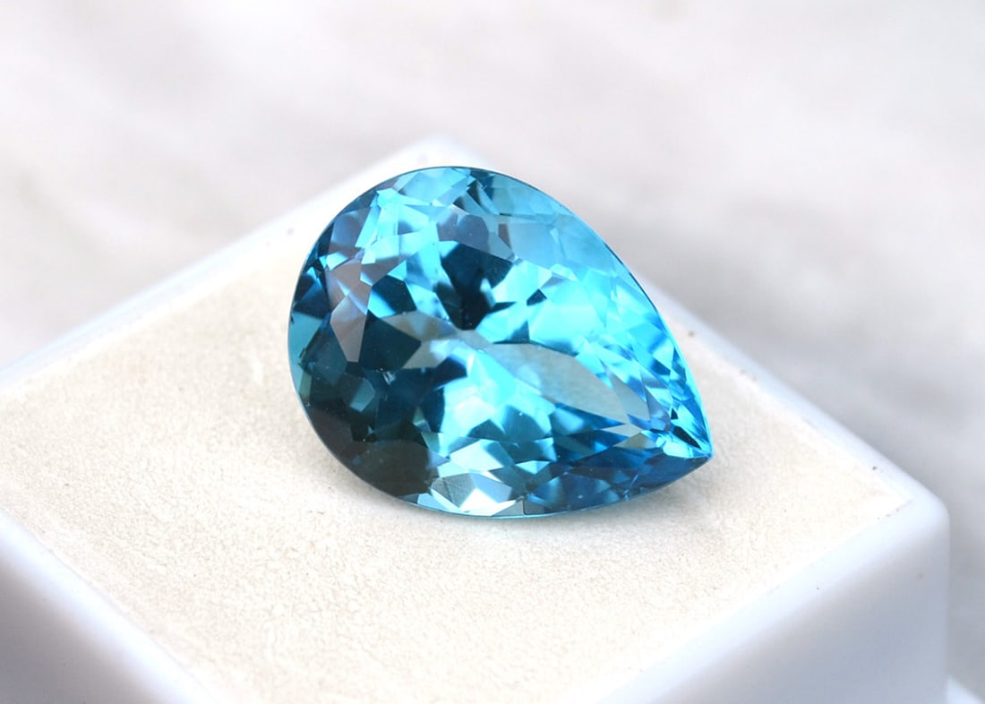 20.31 Carat Pear Cut Intense Sky Blue Topaz: Just a beautiful Sky Blue Topaz here. Natural stone but heated and irradiated to get its color, as all Blue Topaz are. This is an industry accepted practice applied to all Blue Topaz. Most gems sold