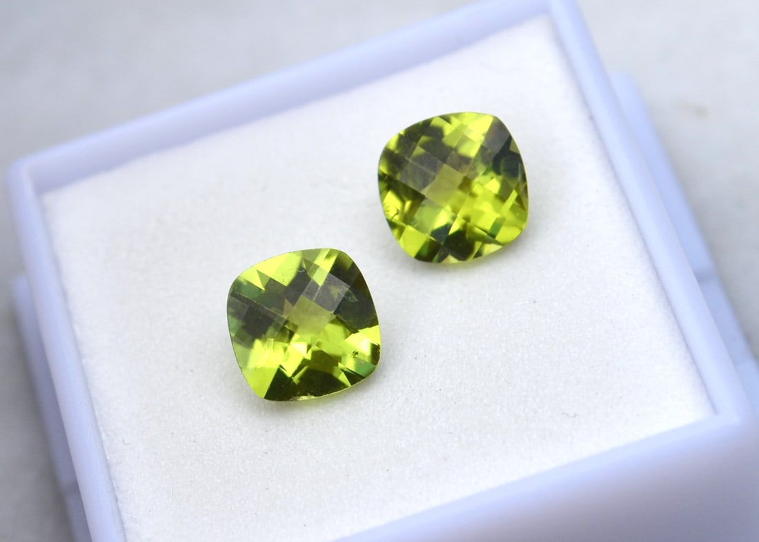 4.15 Carat Matched Pair of Cushion Checkerboard Cut Peridot: Fantastic matched pair of Peridots. Will absolutely pop as earrings. Natural and untreated. Most gems sold online aren't jewelry grade. They're either poorly cut, have weak color or too many inclusion