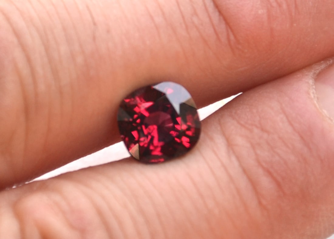 3.94 Carat Cushion Cut Garnet: Fantastic Garnet. Very bright and colorful for its size and mostly clean internally. Nearly all larger Garnets are overly dark and not jewelry grade. This stone would be a fantastic center stone for a