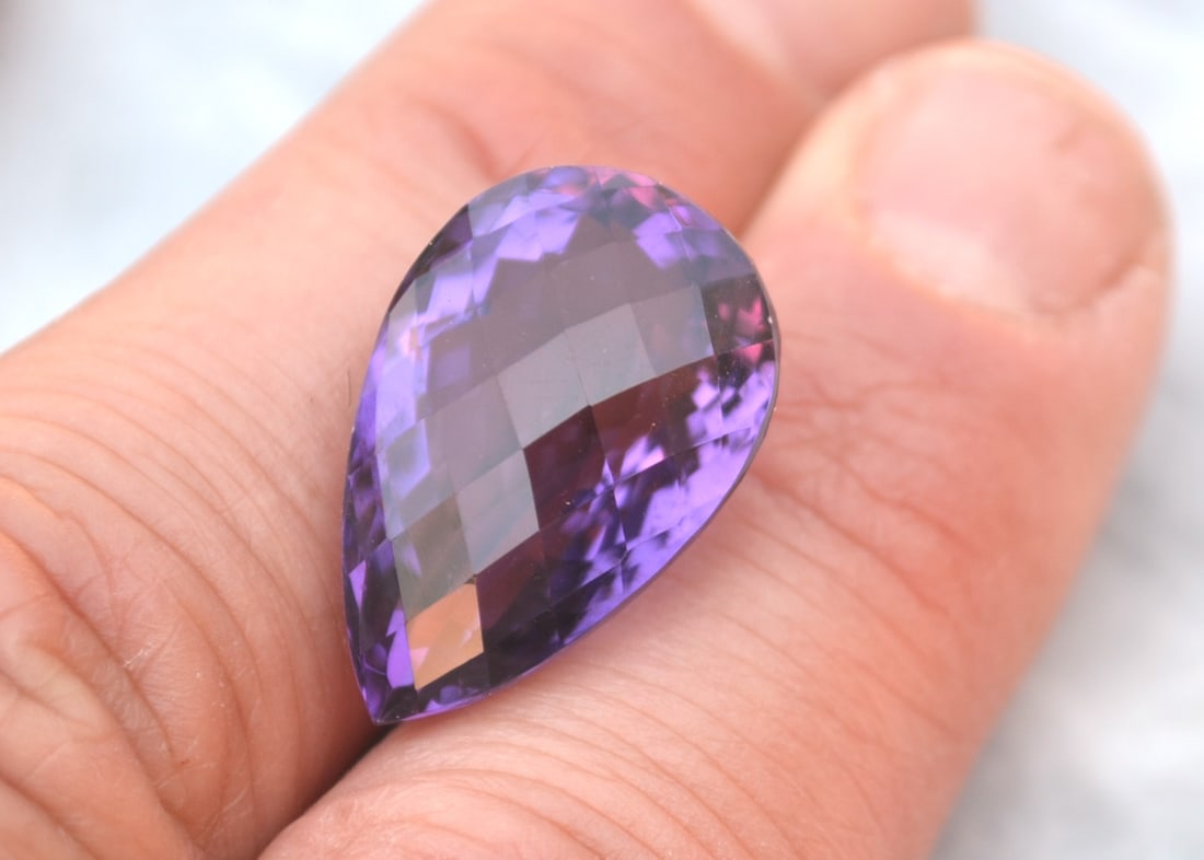 23.58 Carat Pear Checkerboard Cut Amethyst: Gorgeous Amethyst here in every way. Top grade at a fraction of the price. Natural and untreated. Most gems sold online aren't jewelry grade. They're either poorly cut, have weak color or too many inc