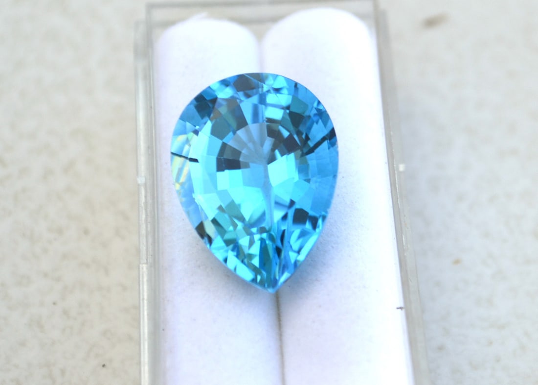 22.40 Carat Fancy Pear Cut Intense Sky Blue Topaz: Fantastic Topaz in every way. Top grade stone at a fraction of the price. Natural stone but heated and irradiated to get its color as all Blue Topaz are. This is an ndustry accepted practice that