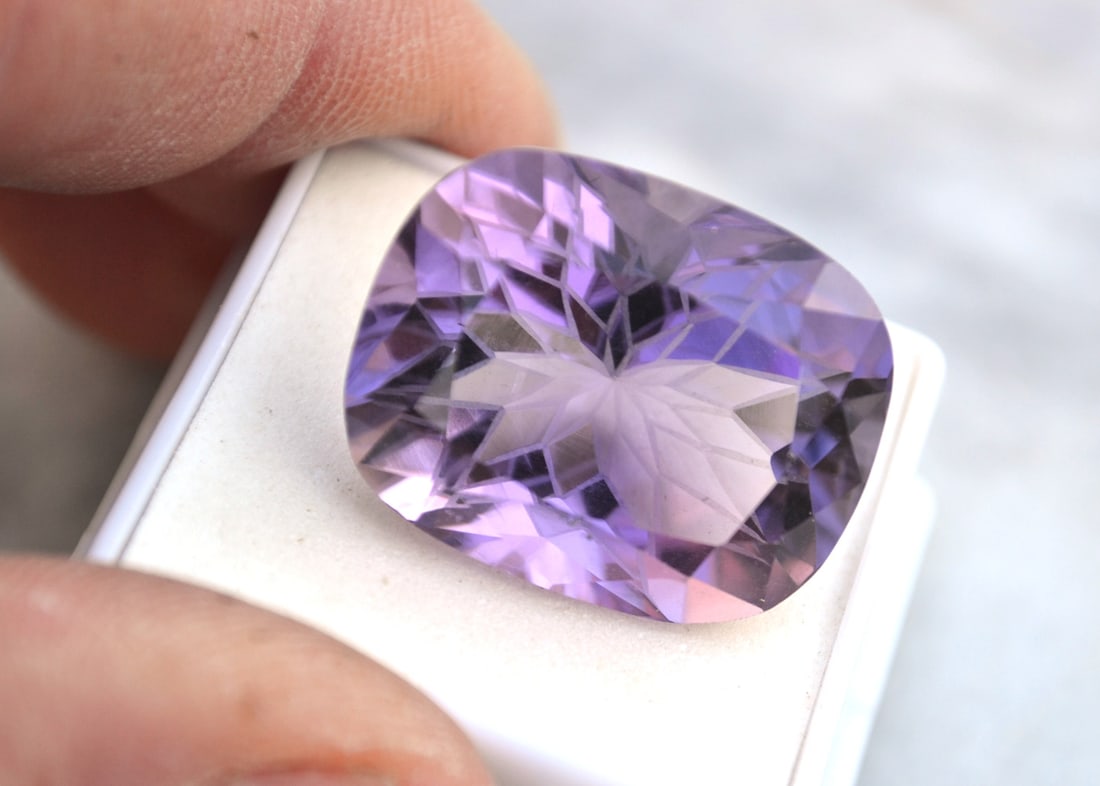 40.36 Carat Fancy Snowflake Cut Amethyst: Beautiful Amethyst with a fancy snowflake pattern carved into the pavilion of the stone. Some of the facets on the reverse have been frosted to give it this one of a kind look. You won'f find a nicer