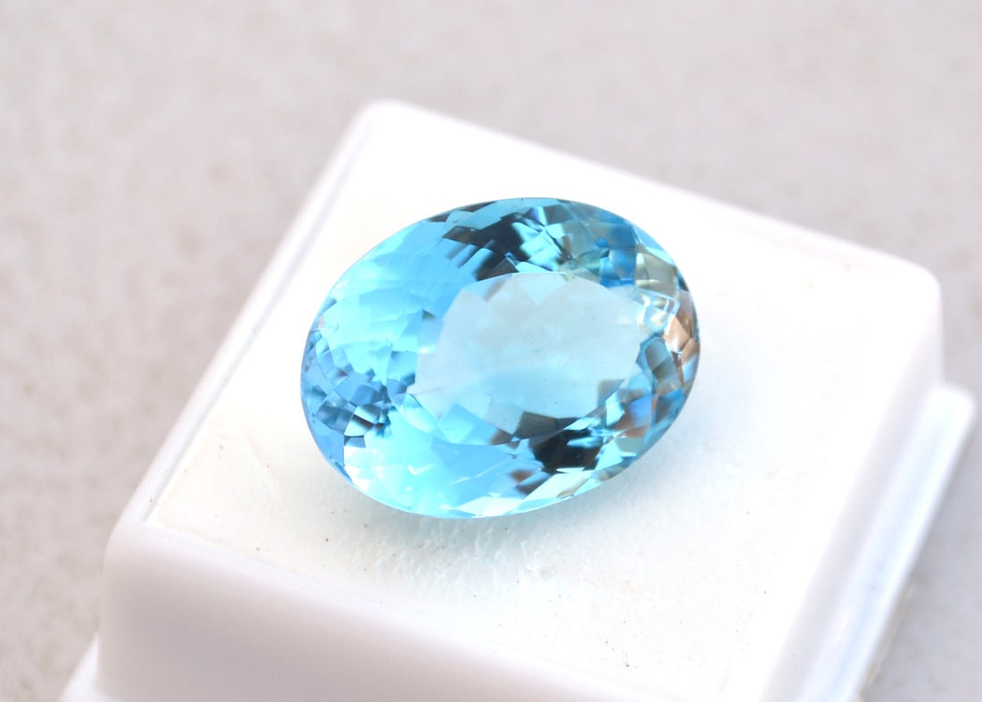 27.30 Carat Oval Cut Sky Blue Topaz: Beautiful Topaz. Great color and nice size for jewelry. Natural stone but heated and irradiated to get its color, as all Blue Topaz are. This is an industry accepted practice applied to all Blue Topaz