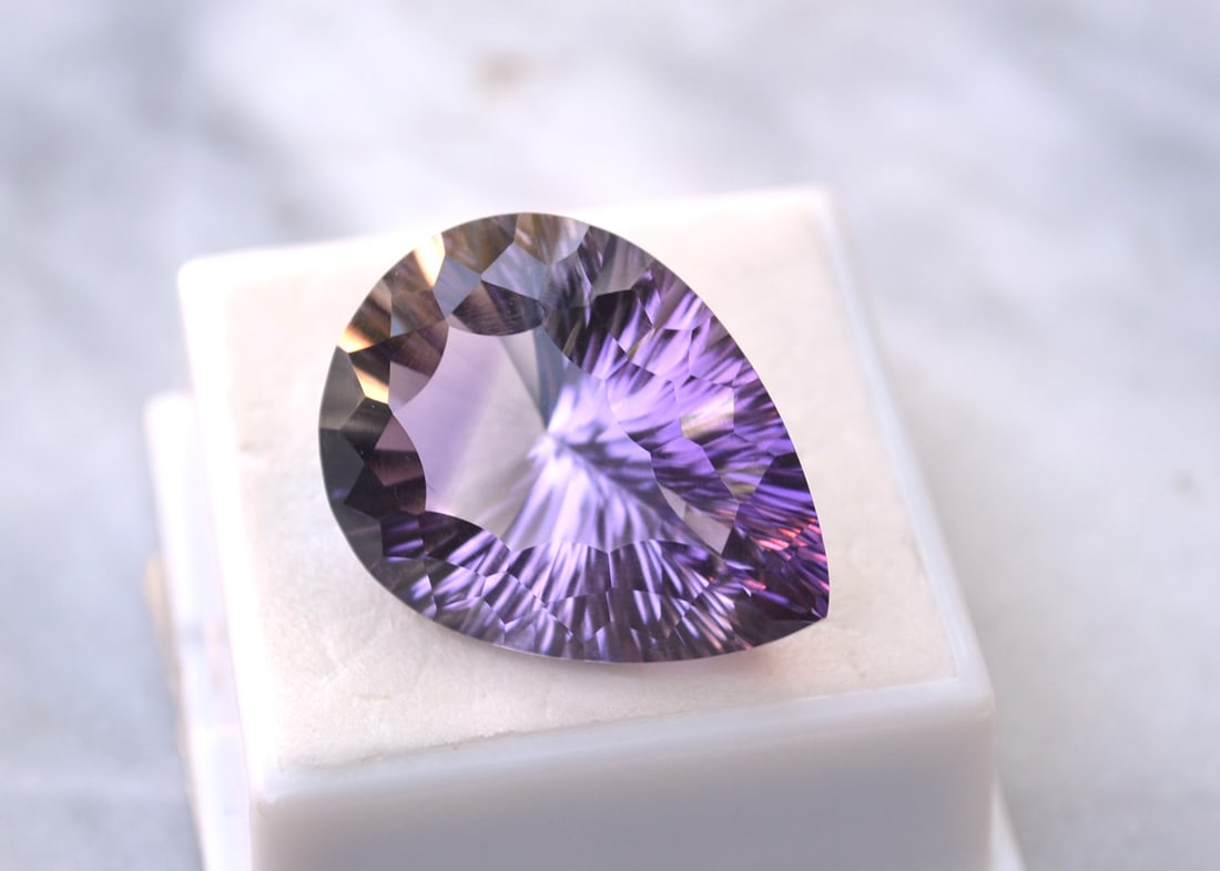 34.42 Carat Fancy Pear Cut Amethyst: Great Amethyst. Large and richly colored. Just a great stone for the price. Natural and untreated. Most gems sold online aren't jewelry grade. They're either poorly cut, have weak color or too many in