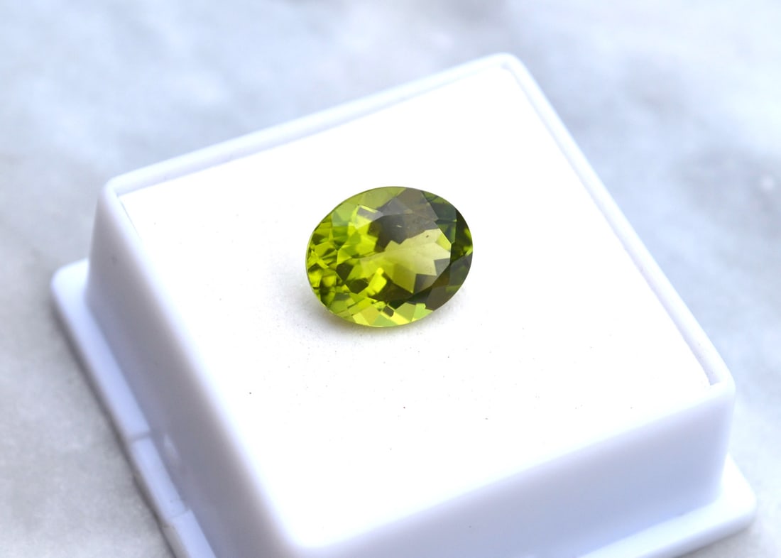 4.92 Carat Oval Cut Peridot: Beautiful Peridot. Great color and cut and mostly clean internally. Just a great stone for the price. Natural and untreated. Most gems sold online aren't jewelry grade. They're either poorly cut, have