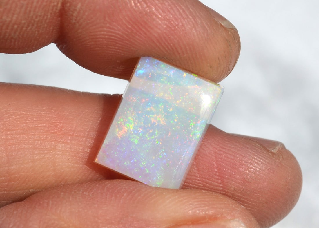 9.90 Carat Bright and Fiery Australian Opal: Beautiful Opal from Australia. Bright and fiery color. Solid Opal. No cracks. Highly valuable stone. Natural and untreated. For Proxibid bidders, shipping is a flat rate of $6, no matter how many lots