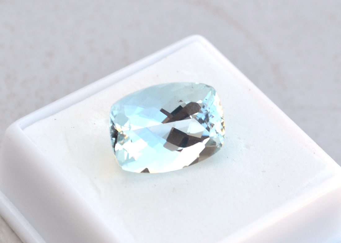 10.25 Carat Cushion Cut Aquamarine: Beautiful Aquamarine. On the lighter end for color, which is why the price is so low. But strong enough color to be used in gold jewelry. This is a jewelry grade Aquamarine. Natural and untreated.