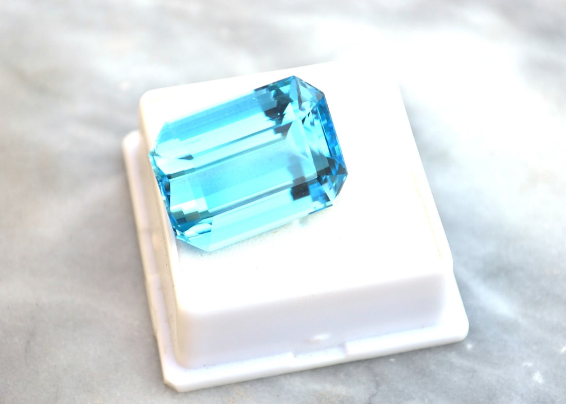 47.87 Carat Octagon Cut Swiss Blue Topaz: Large and beautiful Topaz. Just about perfect in every respect. Natural stone but heated and irradiated to get its color. All Blue Topaz are irradiated to get their color. This is an industry
