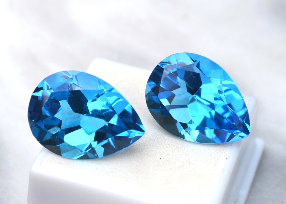 51.88 Carat Matched Pair of Pear Cut Swiss Blue Topaz: Just a magnificent matched pair of Swiss Blue Topaz. Top quality stones. Natural stones but heated and irradiated to get their color, as all Blue Topaz are. This is an industry accepted practice