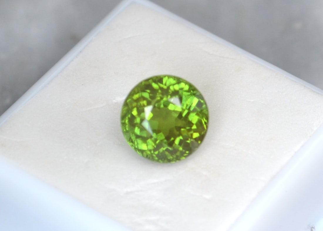 7.53 Carat Round Cut Peridot: Gorgeous Peridot with great color, clarity and cut. Has a fairly deep cut, which is why the price isn't higher. Natural and untreated. Most gems sold online aren't jewelry grade. They're either poorly