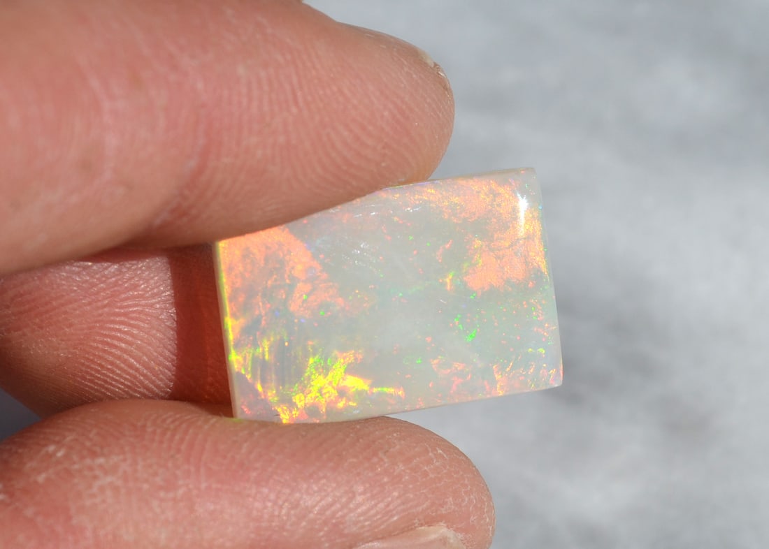 9.07 Carat Bright And Fiery Australian Opal: Beautiful Opal from Australia. Bright and fiery color. Solid Opal. No cracks. Highly valuable stone. Natural and untreated. For Proxibid bidders, shipping is a flat rate of $6, no matter how many lots