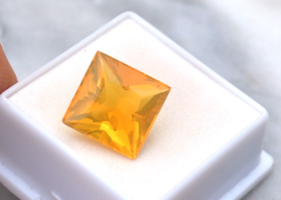 8.50 Carat Princess Cut Fire Opal: Gorgeous Fire Opal, most likely from Brazil. Fine Orangy Yellow color with a great trillion cut. Fantastic stone for the price. Natural and untreated. Most gems sold online aren't jewelry grade. They'