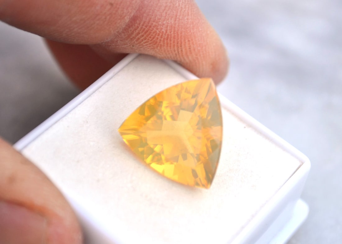 8.64 Carat Trillion Cut Fire Opal: Gorgeous Fire Opal, most likely from Brazil. Fine Orangy Yellow color with a great trillion cut. Fantastic stone for the price. Natural and untreated. Most gems sold online aren't jewelry grade. They'
