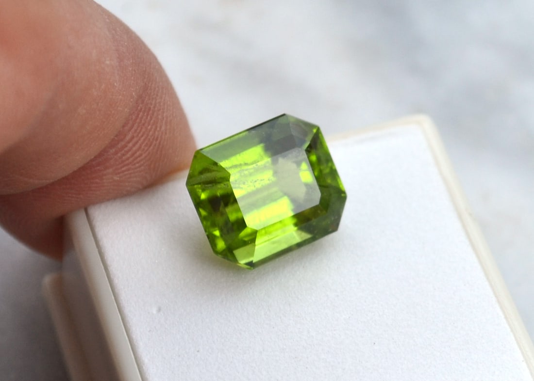 11.21 Carat Certified Octagon Cut Peridot: Wow, what a large and beautiful Peridot. Comes with a nice certification dossier. Peridots over 10 carats are exceptionally rare in this condition. Has an inclusion, which is fairly minor. If this sto