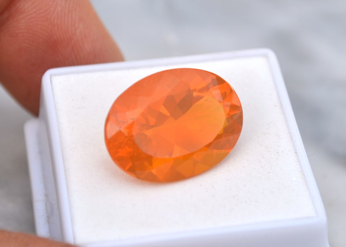 12.60 Carat Oval Cut Brazilian Fire Opal: Top quality Opal in every way. Vibrant color, perfect clarity and an amazing cut. Truly the best of the best. Natural and untreated. Most gems sold online aren't jewelry grade. They're either poorly