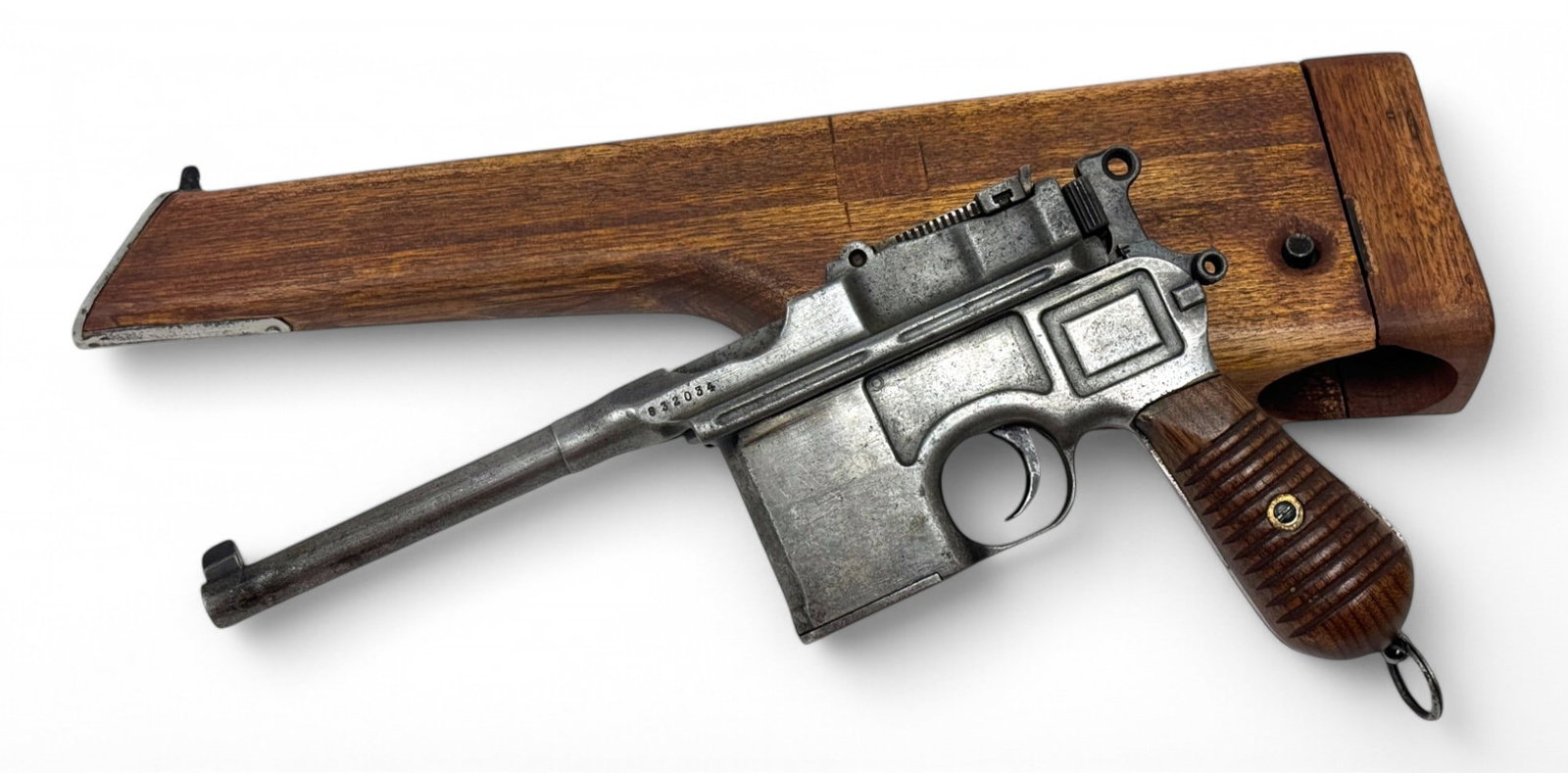 German Mauser 1930 Transitional C96 Broomhandle Semi-Automatic Pistol with Wooden Stock Holster: S#: 832034, mfg. 1930-1932 | 5” Barrel | Non-matching serial numbers | Replacement grips | Comes with a wooden stock holster |||| CONDITION: Fair. Dull gray bare metal finish. Mostly a smooth su