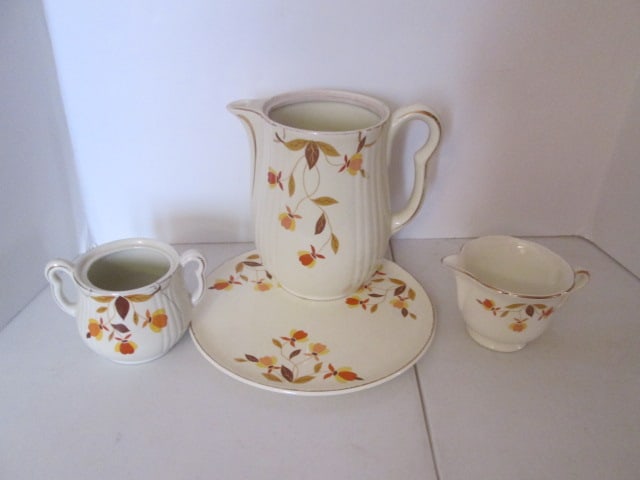 Vintage Hall's Superior Jewel Tea "Autumn Leaf" Coffee Pot, Creamer, Sugar Bowl and Trivet: Coffee pot 7 3/4"h(does not have lid and has crack on bottom), Creamer 3"h, Sugar bowl 4"h(does not have lid and has crack), Trivet plate 9 1/4"dia, all have some wear to gold accents