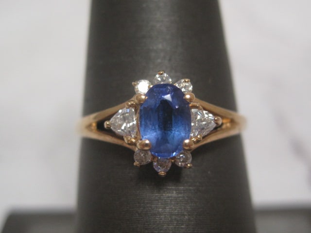 14k Gold Sapphire and Diamond Ring: Rich Oval Sapphire and 8 Round Diamonds. Weighs 2 grams. Size 7 1/4
