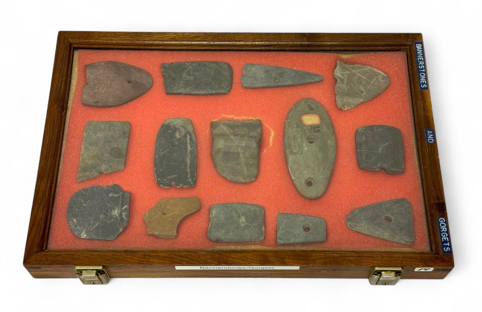 14pc. Curated Ancient Native American Bannerstones & Gorgets Cased Display: 14 pieces in total of Slate/hardstone bannerstones & Gorgets mostly from Ohio. Many partial. Case Measures 18” x 12” and comes with Key.