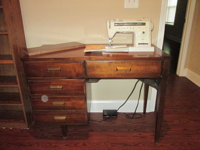 Singer Stylist Zig-Zag Sewing Machine in Wood Sewing Cabinet: Model 534, powers on and needle moves freely, sewing cabinet drawers has sewing sundries and Greist Buttonholer. Cabinet measures 41 1/2"x 19 1/4" x 30 1/2". Located Upstairs-Bring Additional Person t