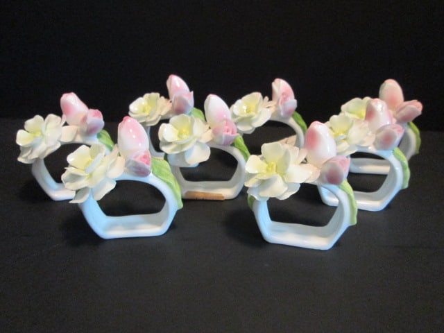 Eight Fine Bone China Napkin Rings with Applied Flowers: .
