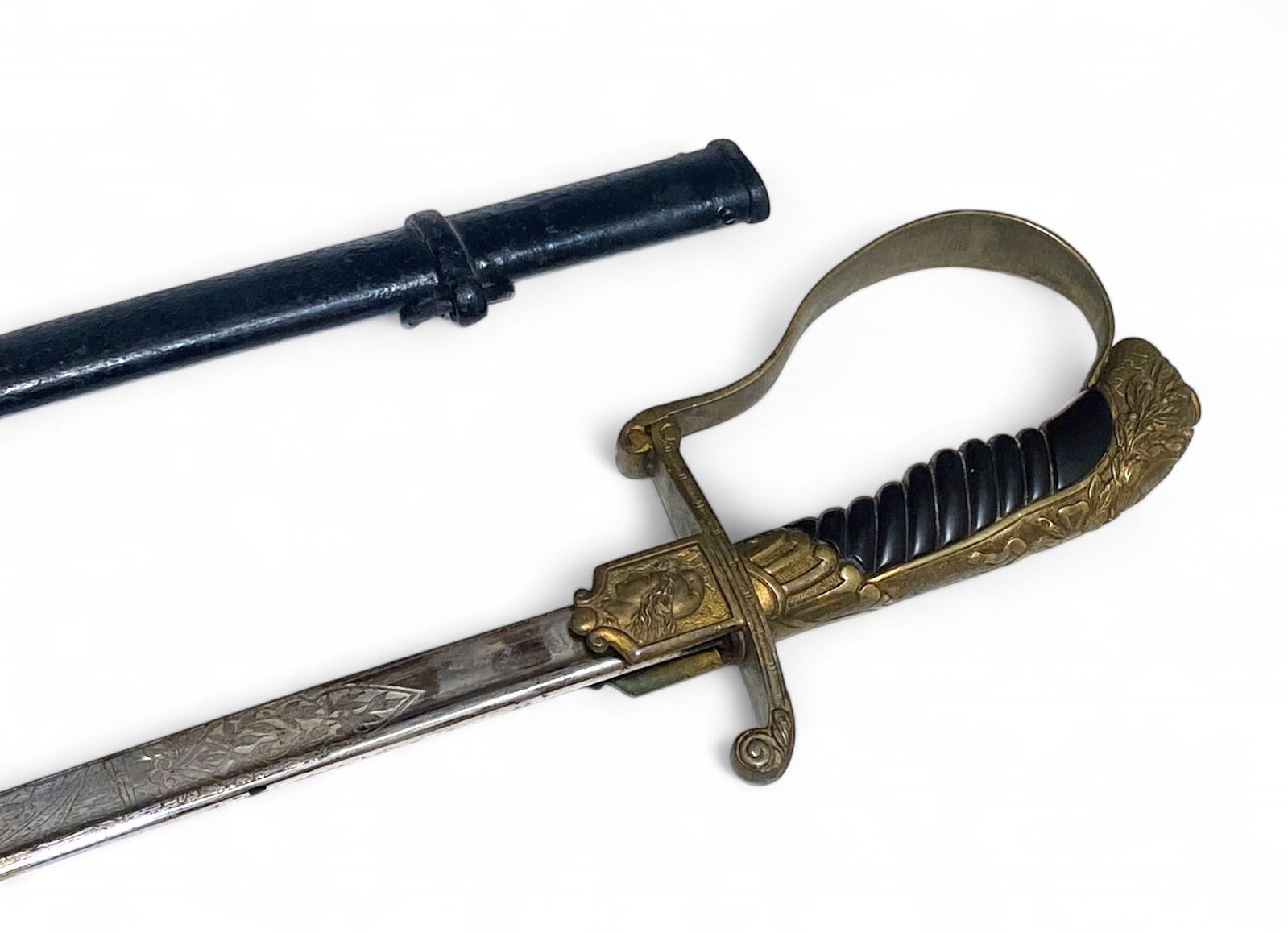 Argentine Army M1910 Officer’s Sword with Scabbard: It has the national anthem "Sean eternos los laureles" etched in the blade | 32" Blade, 37" Overall | Scabbard has dents. Minor wear on the blade and sword overall.