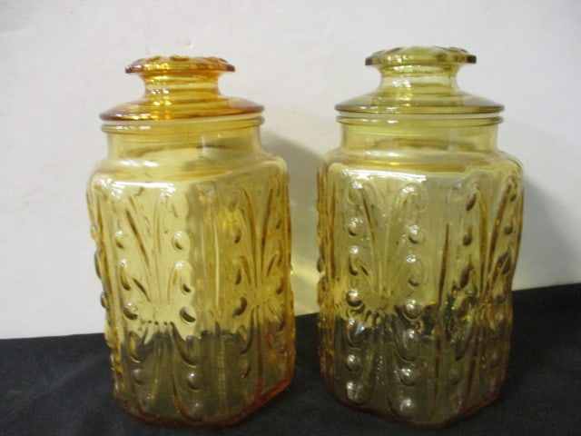 Two Amber Glass Cannisters with Lids.: 9 1/4'' Tall.