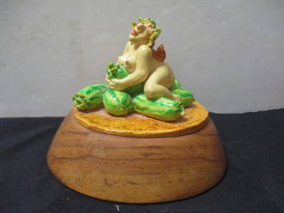 Ceramic Figurine on Wood Base.: 8 x 6 1/2''.
