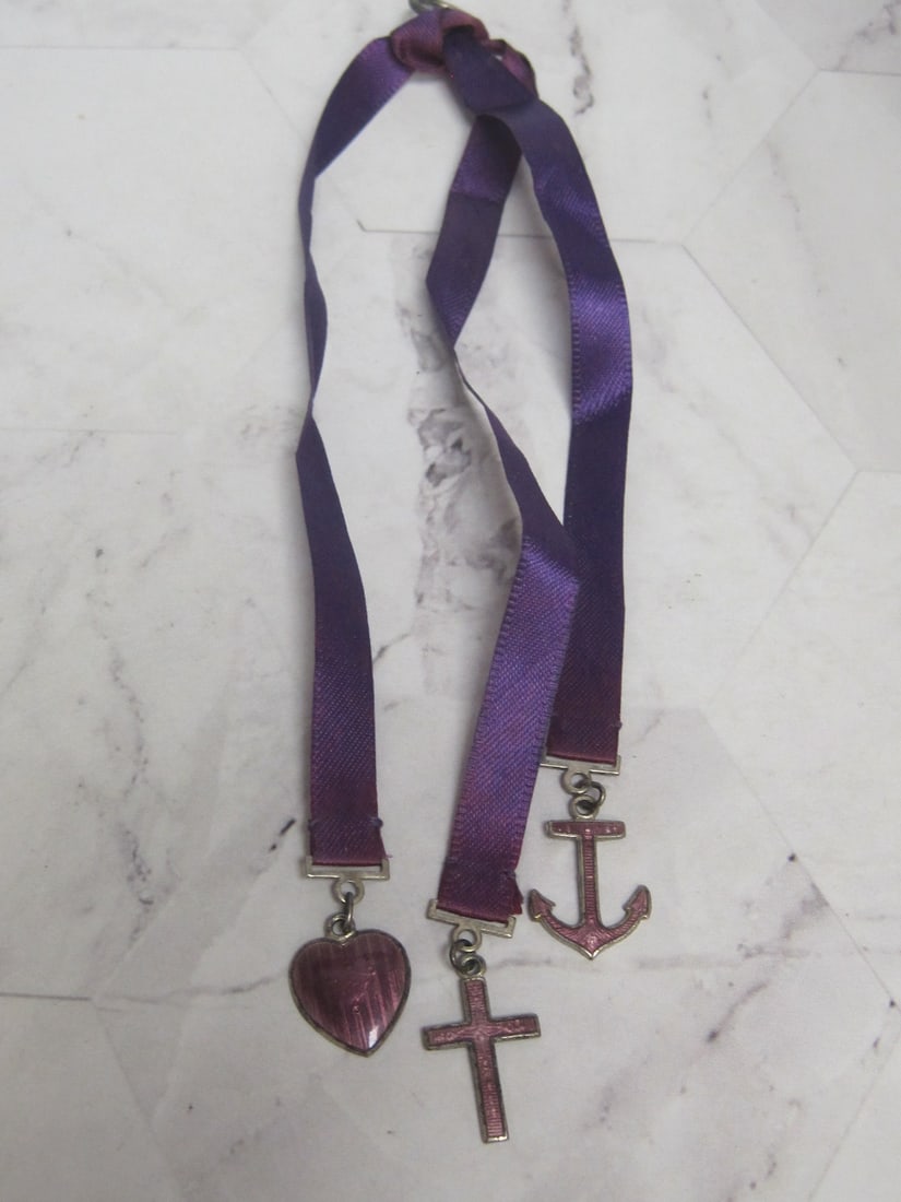 Sterling Silver Faith, Hope and Charity Charms on purple silk: .