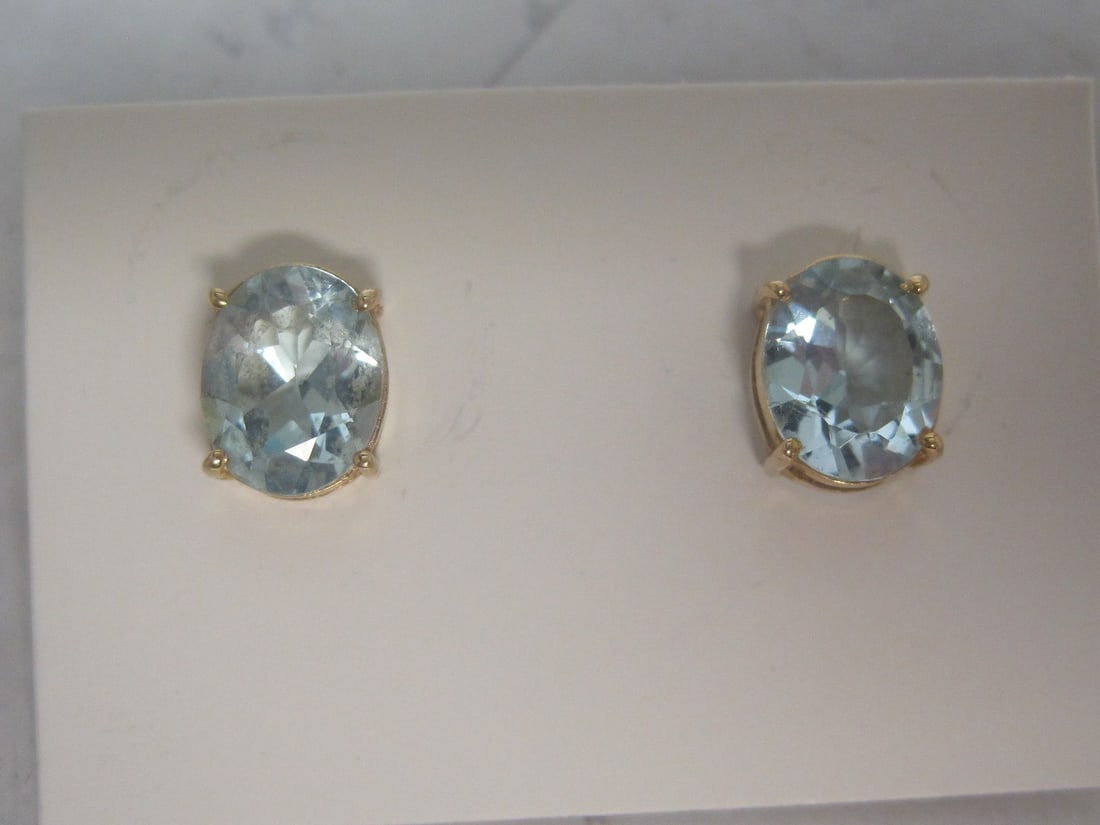 14k Gold Blue Topaz Pierced Earrings: 2 Carat Oval Gems. Weighs 2.2 grams