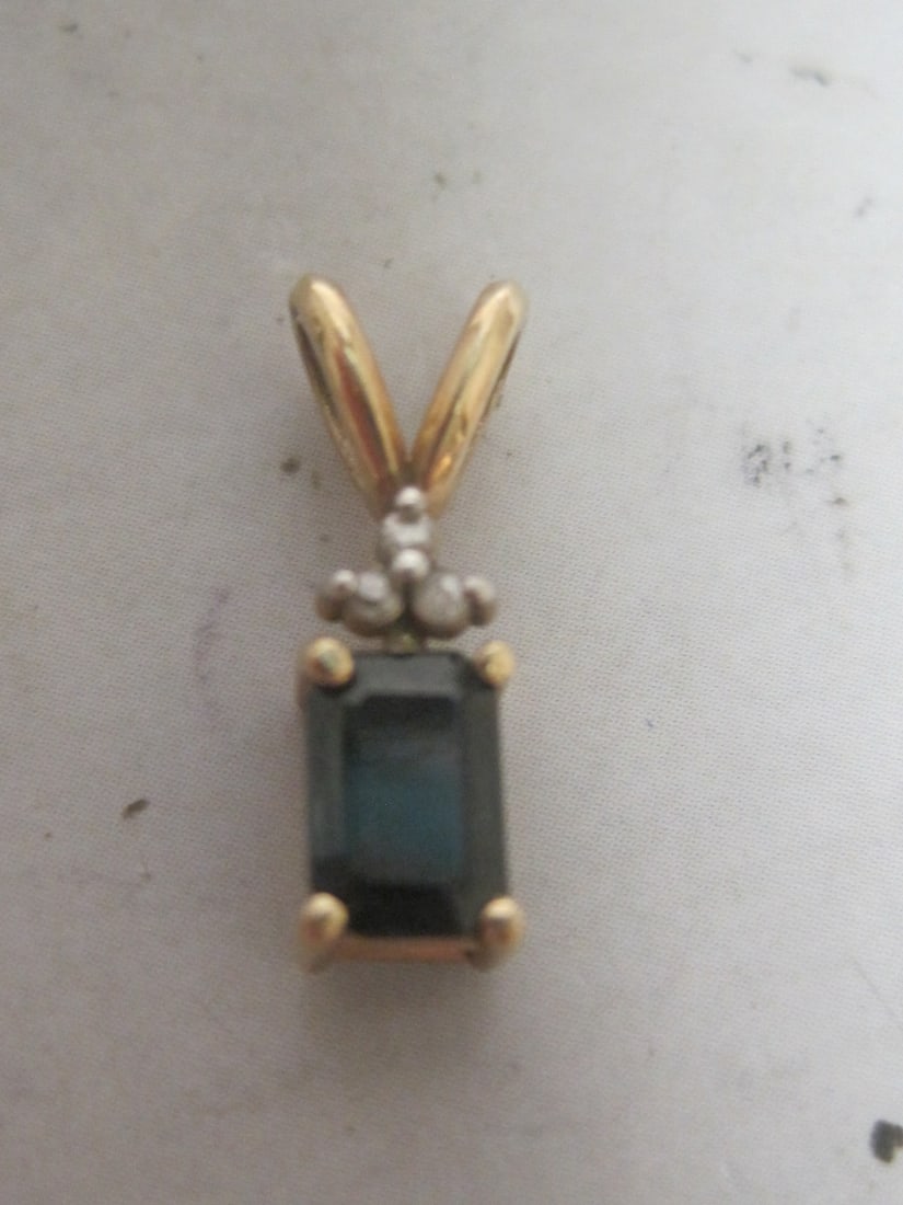14k Gold Sapphire and Diamond Pendant: Emerald Cut Gem with 3 Diamonds Above. Weighs .7 grams