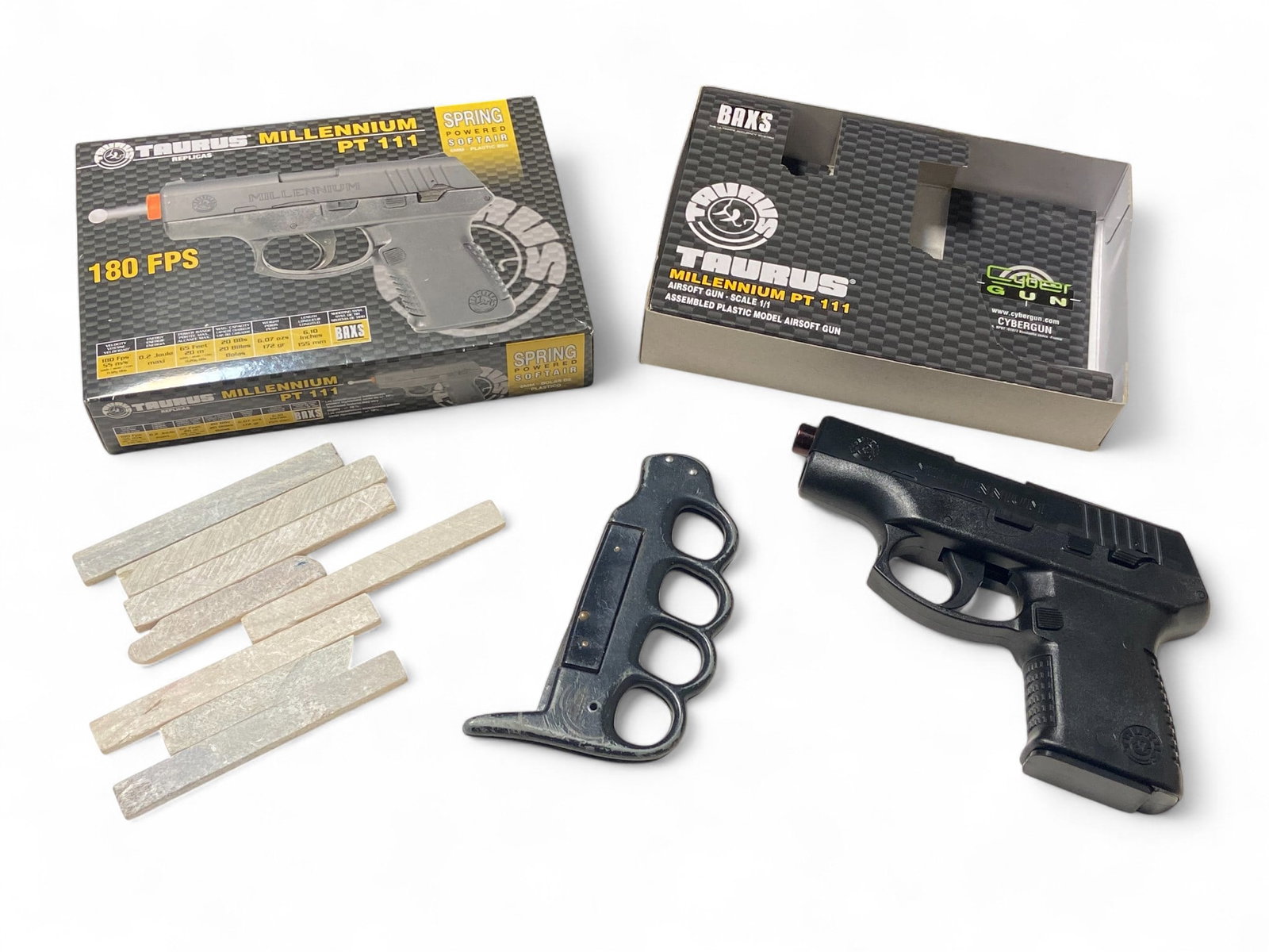 Taurus Millennium PT 111 Model Airsoft Gun, Knuckle Knife and (8) Slate Soapstone Markers: Knuckle Knife has broken blade. Taurus model replica airsoft gun is scale 1/1. Mechanically functions. Appears to be in excellent condition and comes with pellets. Soapstone markers look to be in good