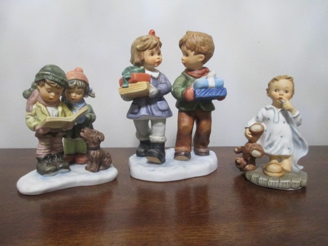 Three Goebel Berta Hummel Porcelain Figurines: 2002 "Tuck Me In" #BH 205-4 1/4"h, 1996 "Holiday Harmony" #BH 18-4 1/2"h, 2002 "Gifts for Grandma" #BH 191-6"h