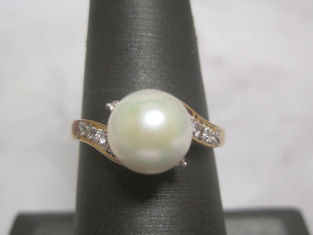 14k Gold Pearl and Diamond Ring: Lusterous 9mm Pearl and 8 round diamonds. Size 7 1/2. Weighs 3.5 grams