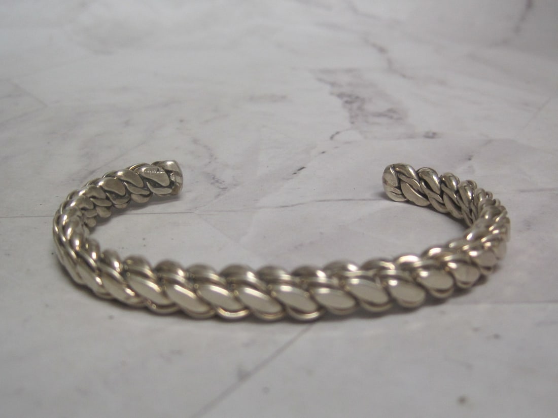 Sterling Silver Braided Rope Style Cuff Bracelet: Adjustable. Weighs 28 grams