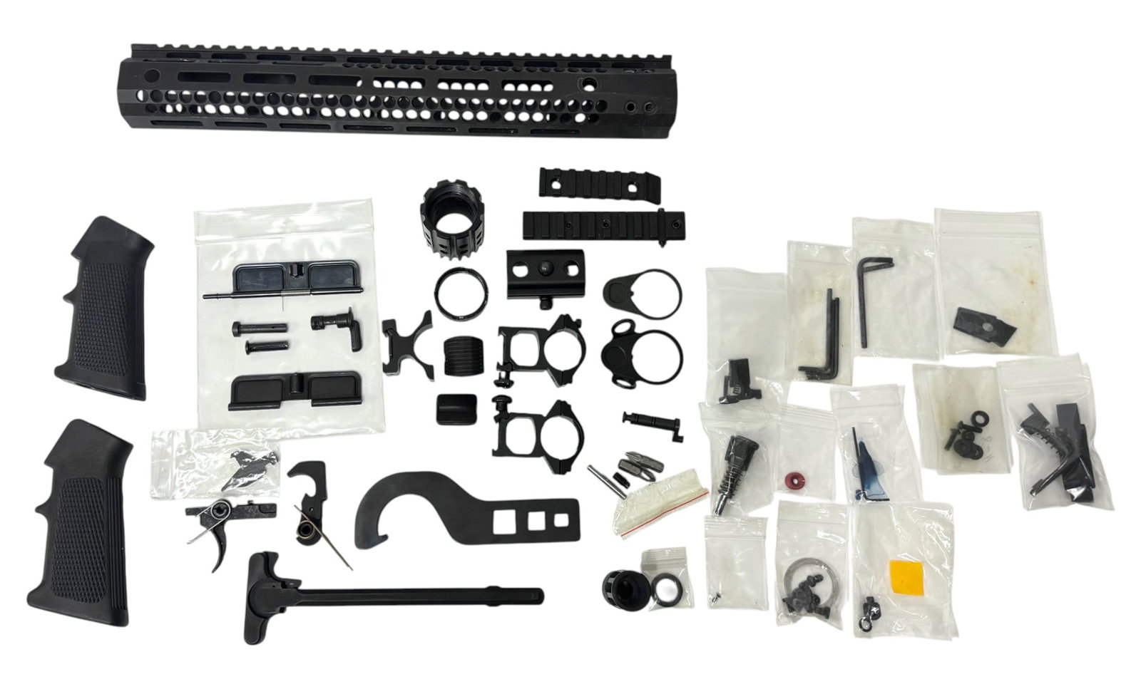 HUGE Assortment of AR15 Parts & Tools: Handguard and barrel nut, (2) Pistol grips, (2) Dust covers, Trigger, Lower parts kit(s), Charging handle, AR Wrench Tool, Scope rings, QD buffer rings, rail attachments, takedown pins, Allen wrenches