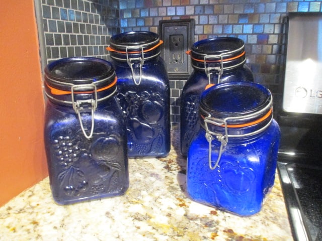 4 Piece Cobalt Blue Lock Lid Cannister Set with Relief Fruit Design: one has taped hole in corner 