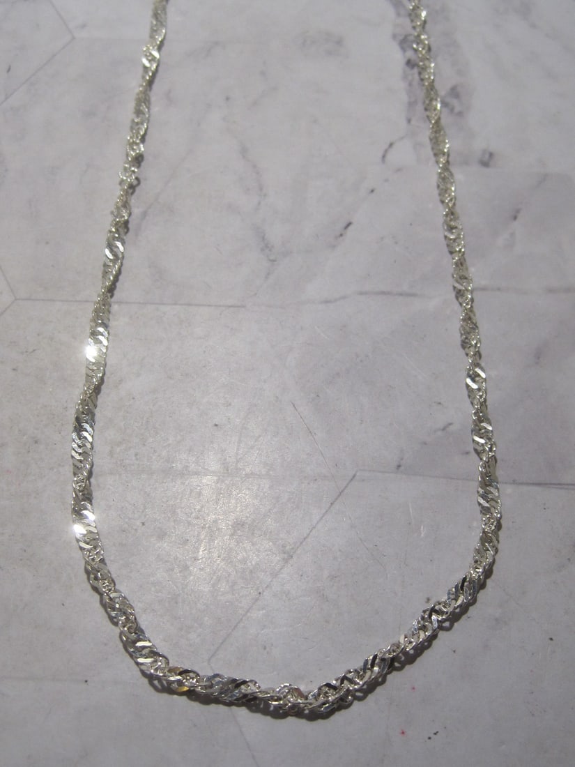 Sterling Silver Chain: Weighs 15 grams, 30" long, Singapore style link 