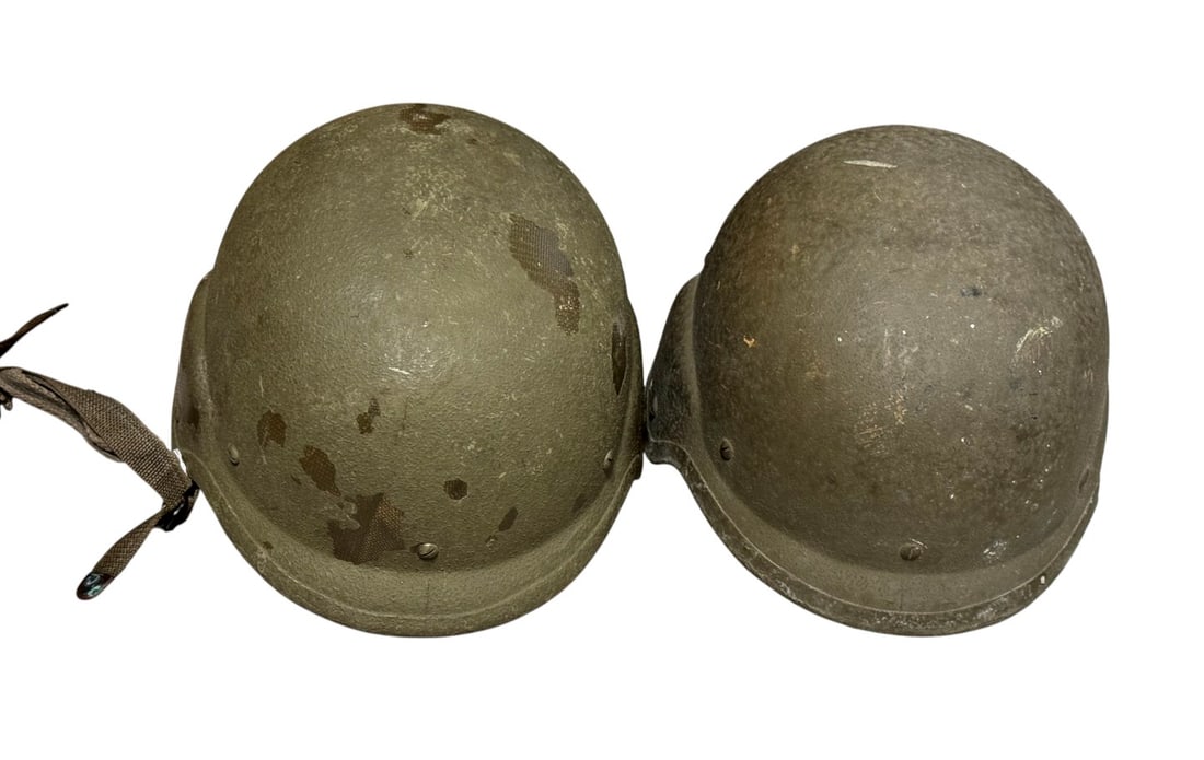 (2) PASGT Ballistic Helmets: (1) 1983 PASGT helmet from Devil Lake, Sioux, size large and (1) 2001 PASGT helmet from Gulf War with Arabic script, size medium
